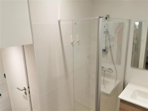 a glass shower in a bathroom with a sink at VILLA Henry - FOCH in Les Sables-dʼOlonne