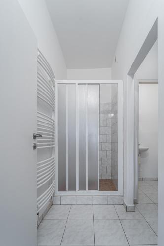 a bathroom with a shower and a glass door at Apartment Yogiam in Slavkov u Brna