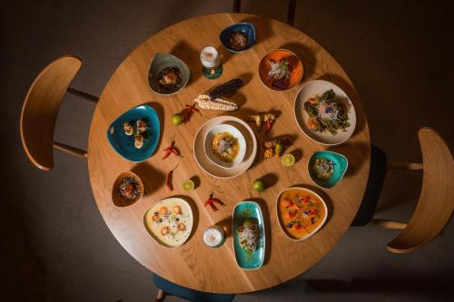 a wooden table with plates of food on it at Eden Roc Resort - All Inclusive in Kallithea Rhodes