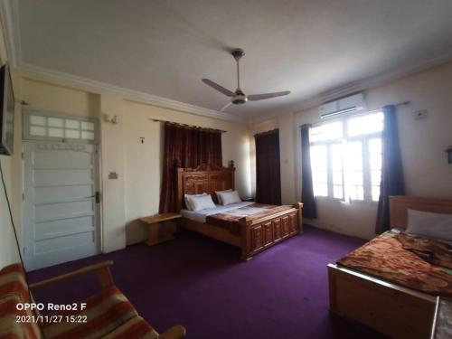 a large room with two beds and a window at FR Darya E Swat Hotel in Mingora