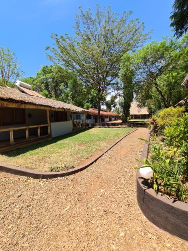a dirt road in front of a building at Honey Badger Lodge in Moshi