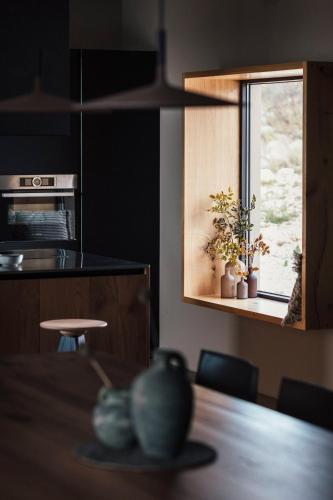a kitchen with a table and a window with plants on it at Villas Misto in Primošten