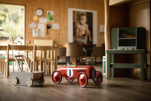 a toy car is sitting on the floor in a room at ALPIANA - green luxury Dolce Vita Hotel in Vollan