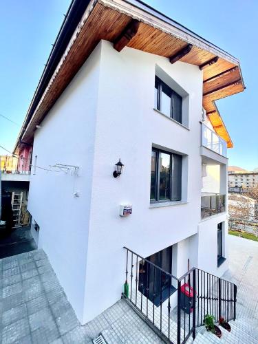a white house with a wooden roof at Stylish loft studio with great view to Ardino in Ardino
