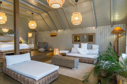 a living room with two couches and a bed at Green Village Resort in Sfântu Gheorghe