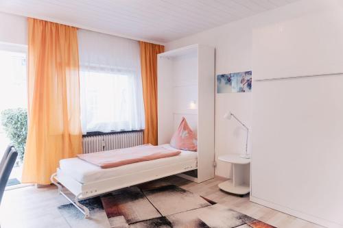 a small bedroom with a bed and a window at Apartment-EG-03 in Darmstadt