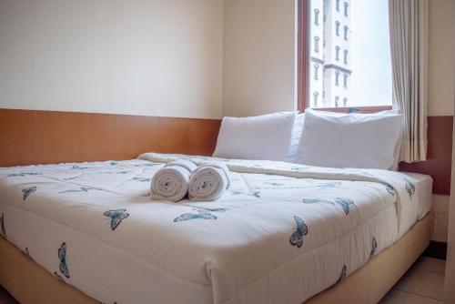 Ένα ή περισσότερα κρεβάτια σε δωμάτιο στο Majesty Homey 2BR Apartment
