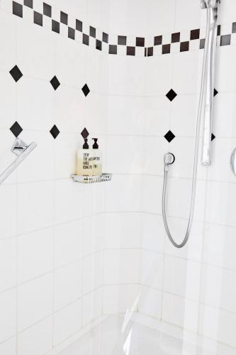 a bathroom with a shower with a cake on the wall at Hotel Landhaus an de Dün in Sankt Peter-Ording