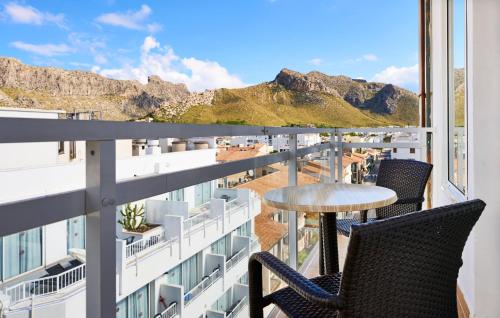 a balcony with two chairs and a table on a building at Hoposa Daina- Adults Only in Port de Pollensa
