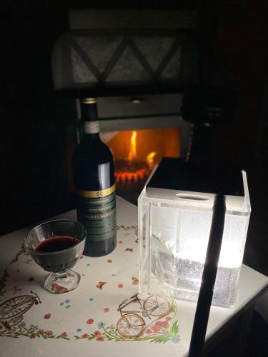 a bottle of wine and a box of glasses on a table at Holiday home at Aquapark Tatralandia in Liptovský Mikuláš
