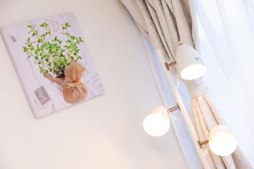 a picture of a rabbit holding a plant on a wall at Awaji Garden House in Shinmura in Sumoto
