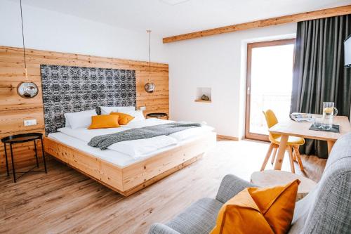 a bedroom with a bed and a table and chairs at Hotel Schönberg B&B in Rio Bianco