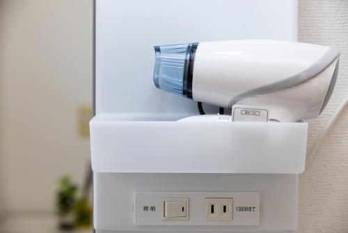 a hair dryer sitting on top of a machine at Awaji Garden House in Shinmura in Sumoto