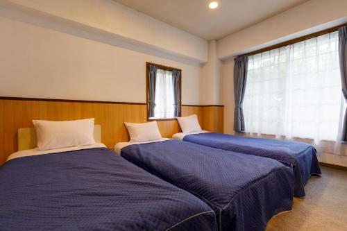 Un pat sau paturi într-o cameră la Tabist More Resort Hakuba Excel