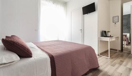 a bedroom with a large bed and a television at Guest House Roma in Rome
