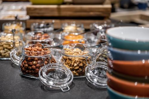 a table topped with jars of nuts and other snacks at Ski & Bike Hotel Wiesenegg in Saalbach Hinterglemm