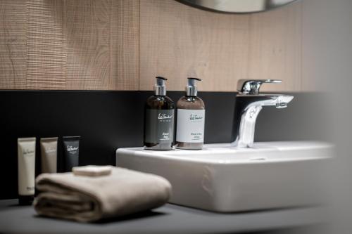 two bottles of wine sitting on top of a sink at Ski & Bike Hotel Wiesenegg in Saalbach Hinterglemm