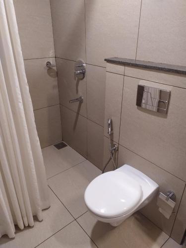 a bathroom with a toilet and a shower at Royal Residency in Kakkanad