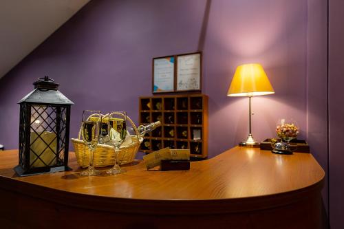 a table with a lamp and baskets of wine bottles at Sonata at Mayakovskogo in Saint Petersburg