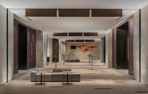 a rendering of a lobby with a couch and tables at Crowne Plaza Xiamen Jimei Seaview by IHG-Free Mini Bar in Xiamen