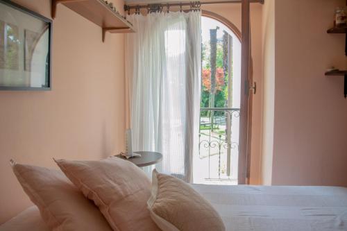 a bedroom with a bed and a large window at Villa Michelangelo - WelcHome in Cannobio