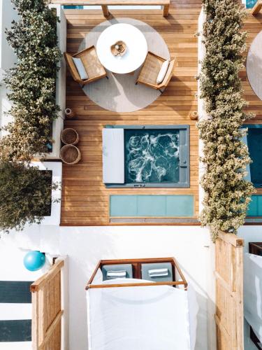 a room with wooden walls and a table and benches at Avgoustos Suites Naxos in Naxos Chora