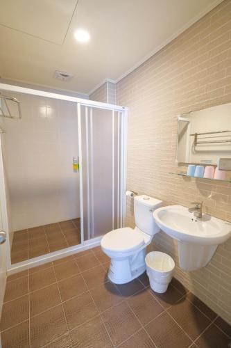 a bathroom with a toilet and a sink and a shower at Anping island in Tainan
