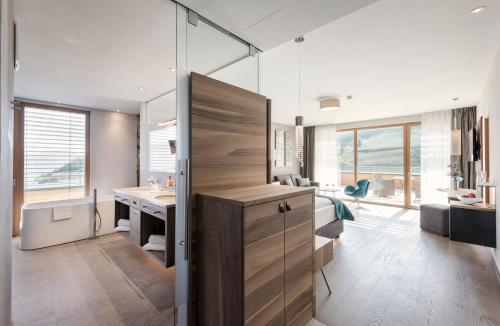 a bedroom with a desk and a room with a deskicterictericterictericter at ALPIANA - green luxury Dolce Vita Hotel in Vollan