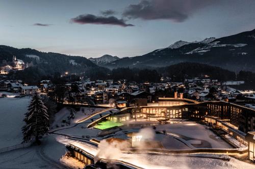 a view of a town in the snow at night at Falkensteiner Family Resort Lido Superior in Chienes