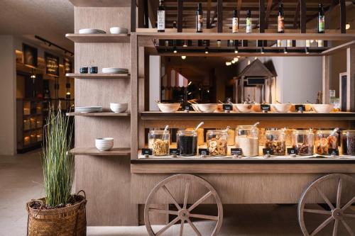 a food cart with food on display in a store at Falkensteiner Family Resort Lido Superior in Chienes