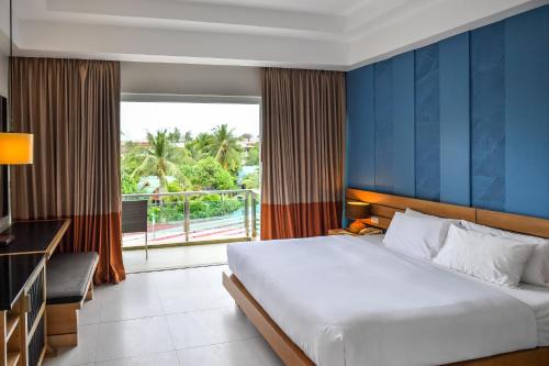 1 dormitorio con 1 cama grande y balcón en Navinda Krabi - SHA Plus, en Ao Nang Beach
