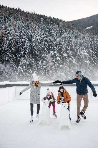a group of people playing in the snow at Falkensteiner Family Resort Lido Superior in Chienes