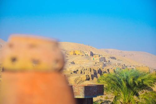a view of a desert with a building on a hill at Rose Guest House in Luxor