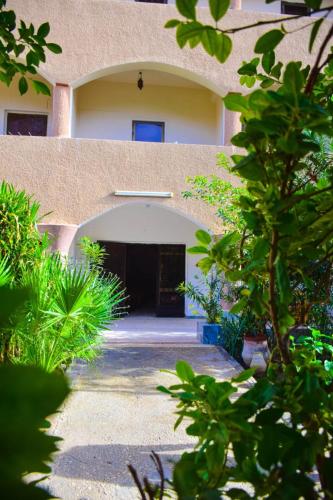 an entrance to a building with a large garage at Rose Guest House in Luxor