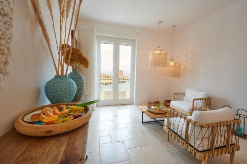 a living room with a bowl of fruit on a table at Musae al Mare in Polignano a Mare