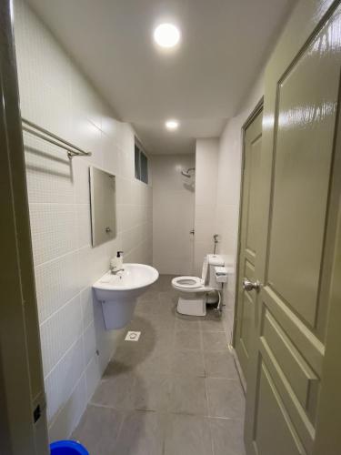 a bathroom with a sink and a toilet and a door at Paradise Penthouse 5 bedrooms 5 bathrooms in Tanah Rata