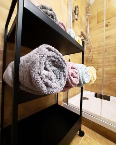 a shelf with towels on it in a bathroom at Bylo Nebylo apartmány in Vítkovice