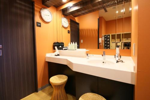 a bathroom with a large sink and a mirror at APA Hotel Asakusa Kuramae in Tokyo
