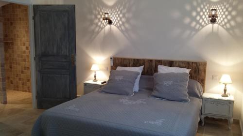 a bedroom with a bed with blue sheets and pillows at Mas Saint Julien in Cavaillon