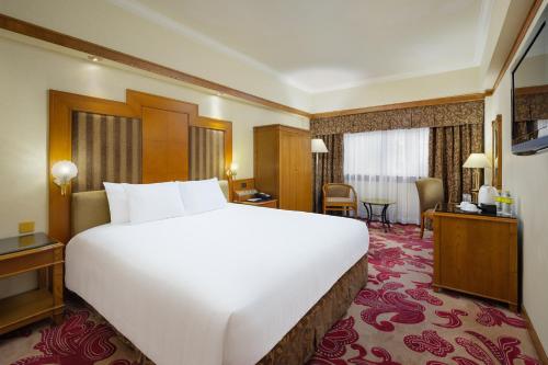 a large white bed in a hotel room at Hotel Sintra in Macau