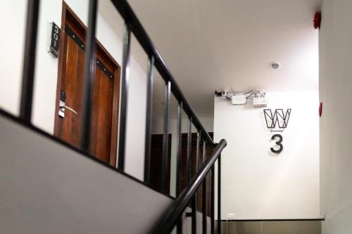 a hallway with a door and a number on the wall at WiRE BANGKOK PRAKHANONG in Amphoe Phra Khanong