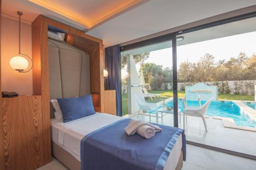 a bedroom with a bed and a balcony with a pool at Orka World Hotel & Aquapark in Oludeniz