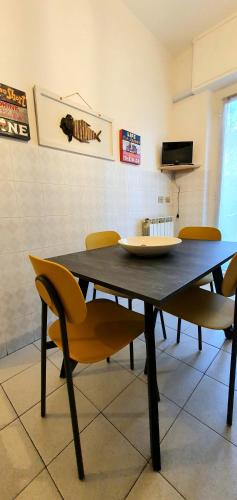 a dining room table with chairs and a plate on it at COMODO AL MARE in Lerici