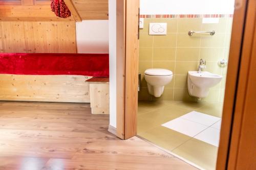 a bathroom with a toilet and a sink at Hotel Alegra in Livigno