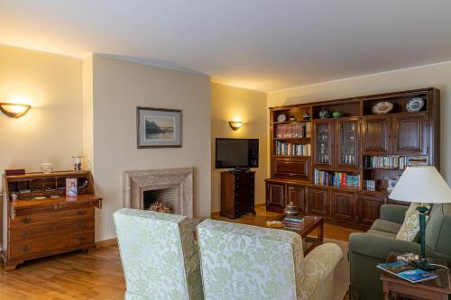 a living room with a couch and a fireplace at Preciosa Apartment by MP in Vila Nova de Gaia