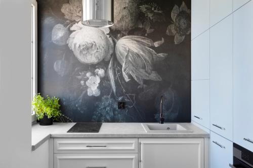 a kitchen with a wall mural of flowers at Elite Apartments Old Town Deluxe in Gdańsk