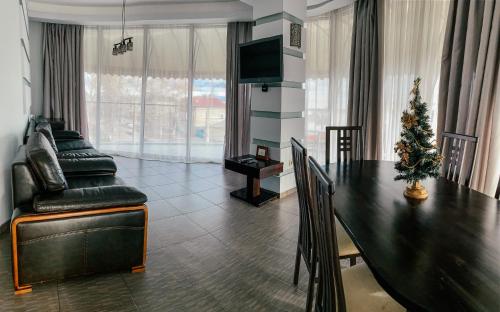 a living room filled with furniture and a large window at Greenstone in Kherson