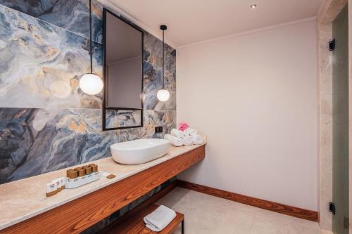 a bathroom with a sink and a mirror at Orka World Hotel & Aquapark in Oludeniz