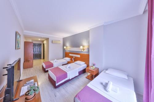 Posteľ alebo postele v izbe v ubytovaní Kas Bilgin Hotel