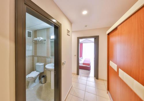 a bathroom with a toilet and a sink at Kas Bilgin Hotel in Kas